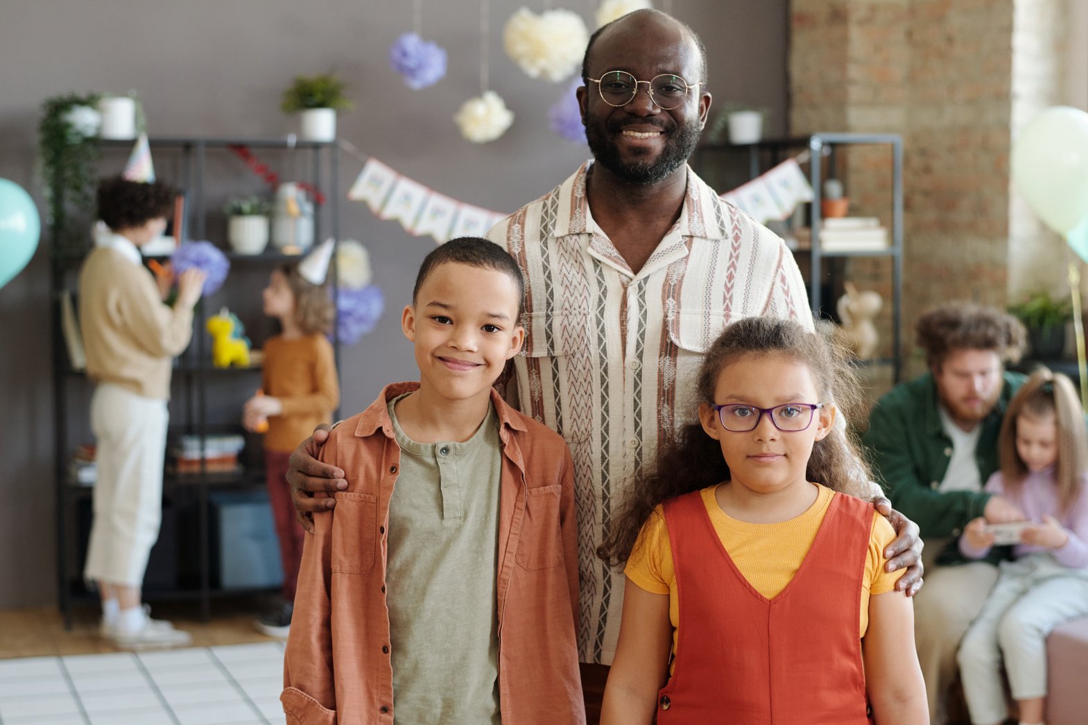 Happy Dad with Kids at Birthday Party